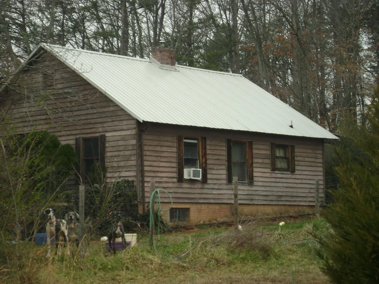 White metal roof on an old wood sided farmhouse, from a Metal Roof Installation job in Carmel